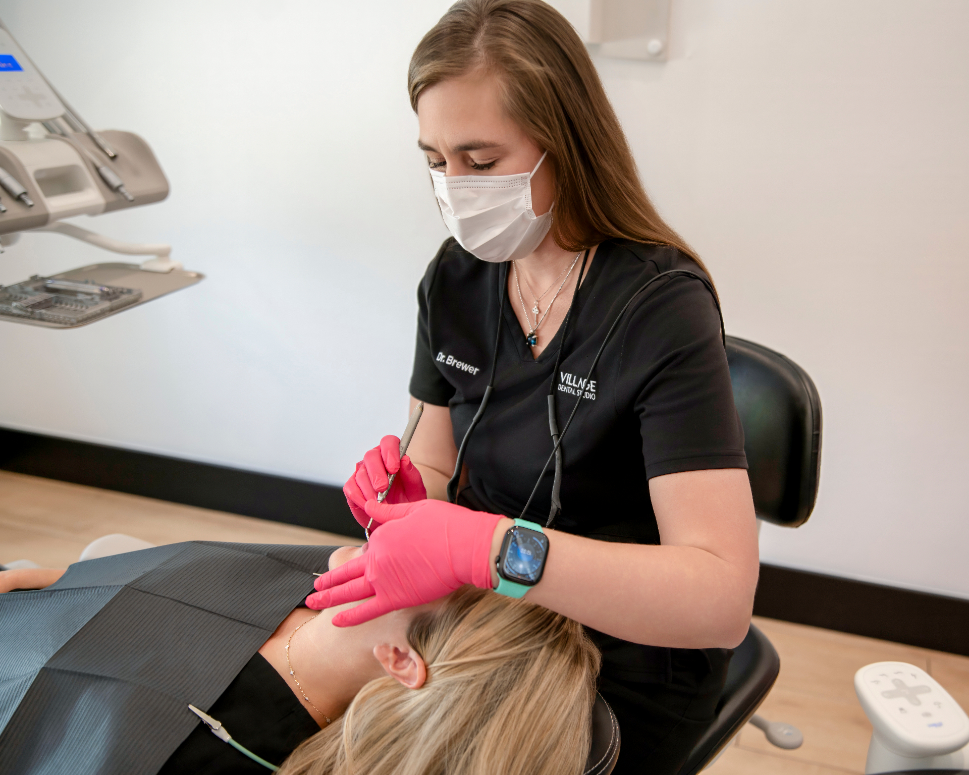 Dr. Allison Brewer treating a patient at Village Dental Studio