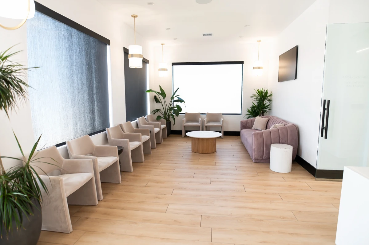 Village Dental Studio lobby lounge with velvet seating and plants