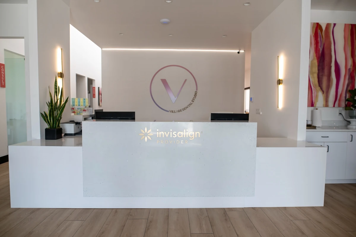 Village Dental Studio reception desk with Invisalign Provider logo