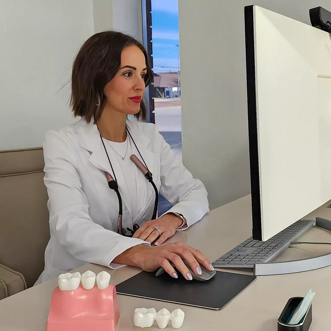 Dr. Traci Leon at a treatment room computer