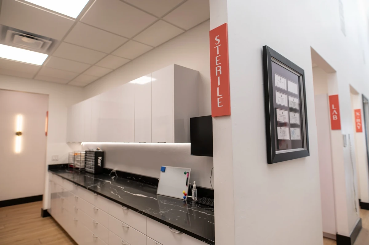Village Dental Studio sterile and lab corridor with credential wall